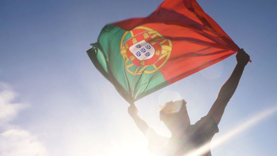 Pessoa a agarrar na bandeira de Portugal